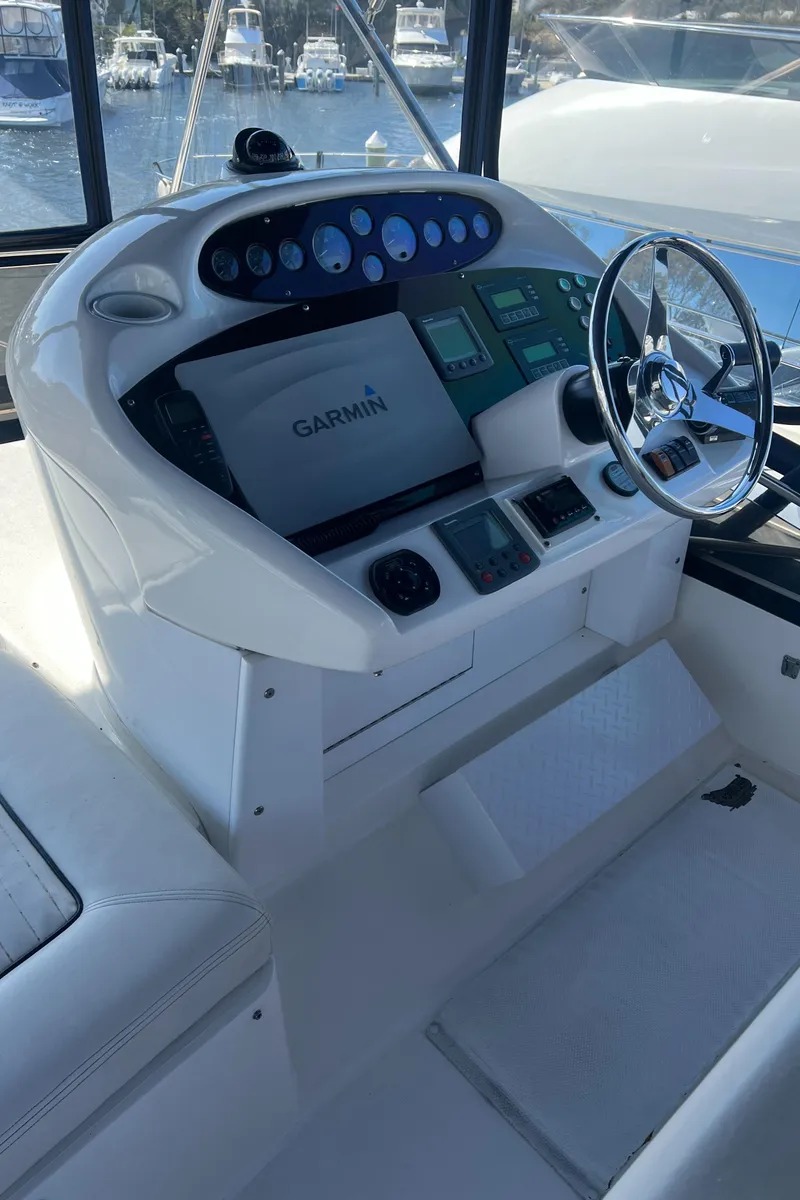 Slide: The Image of 2008 Sunseeker Manhattan 50 yacht helm with Garmin navigation system and modern controls. - 11
