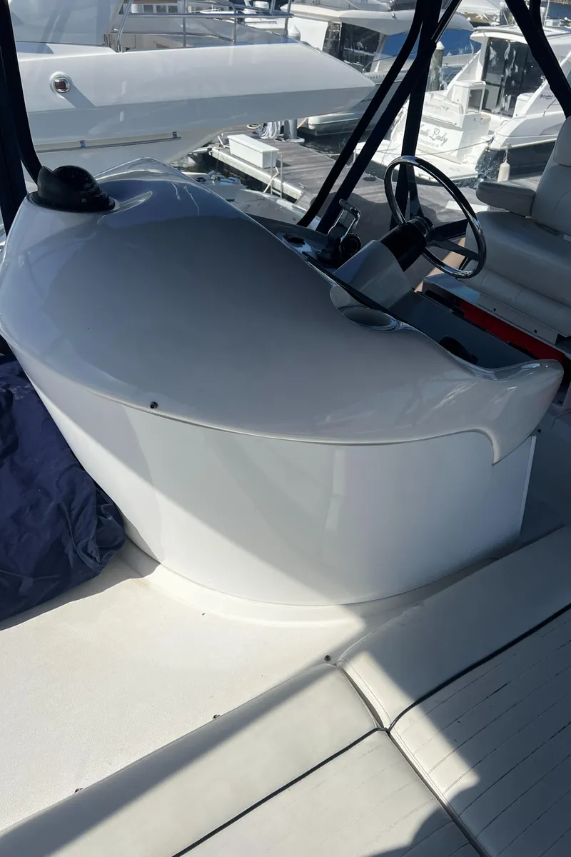 Slide: The Image of 2008 Sunseeker Manhattan 50 yacht helm station with steering wheel and controls. - 12