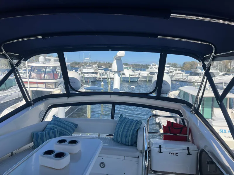 Slide: The Image of 2008 Sunseeker Manhattan 50 yacht interior with marina view, featuring seating and cup holders. - 15