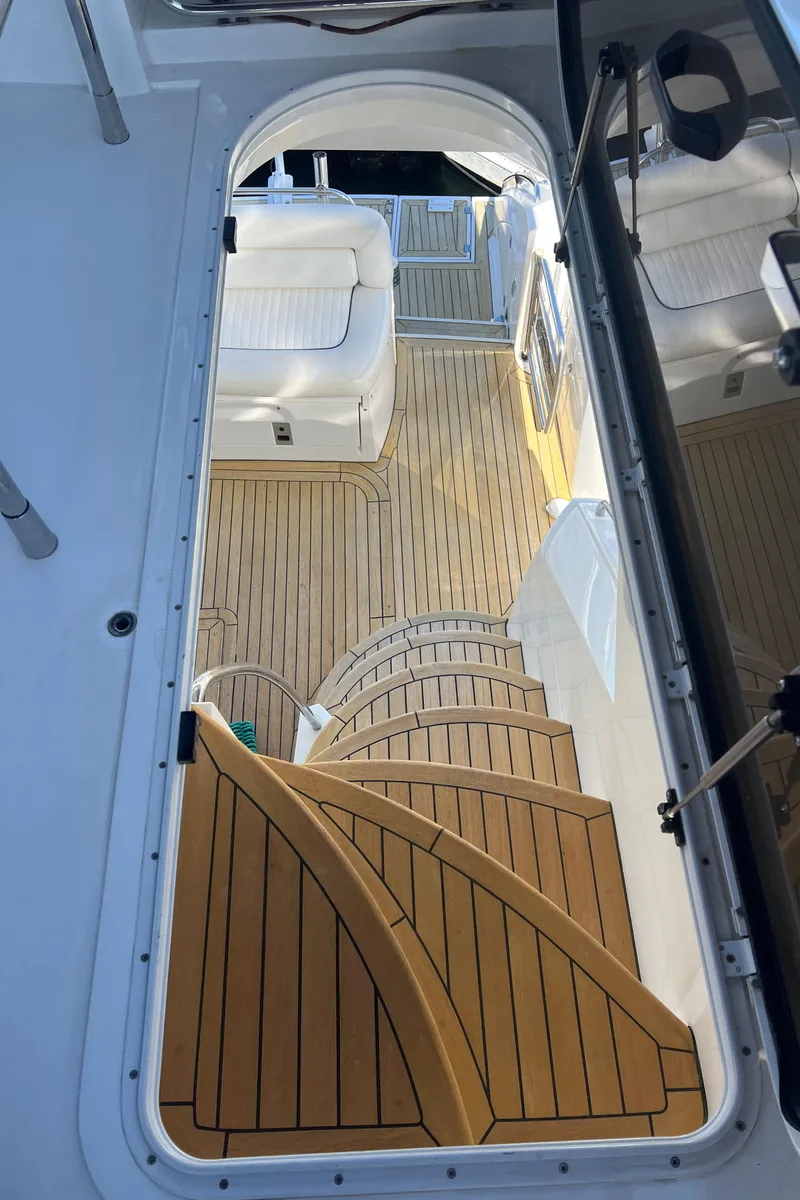 Slide: The Image of 2008 Sunseeker Manhattan 50 yacht interior with wooden stairs and seating area. - 18