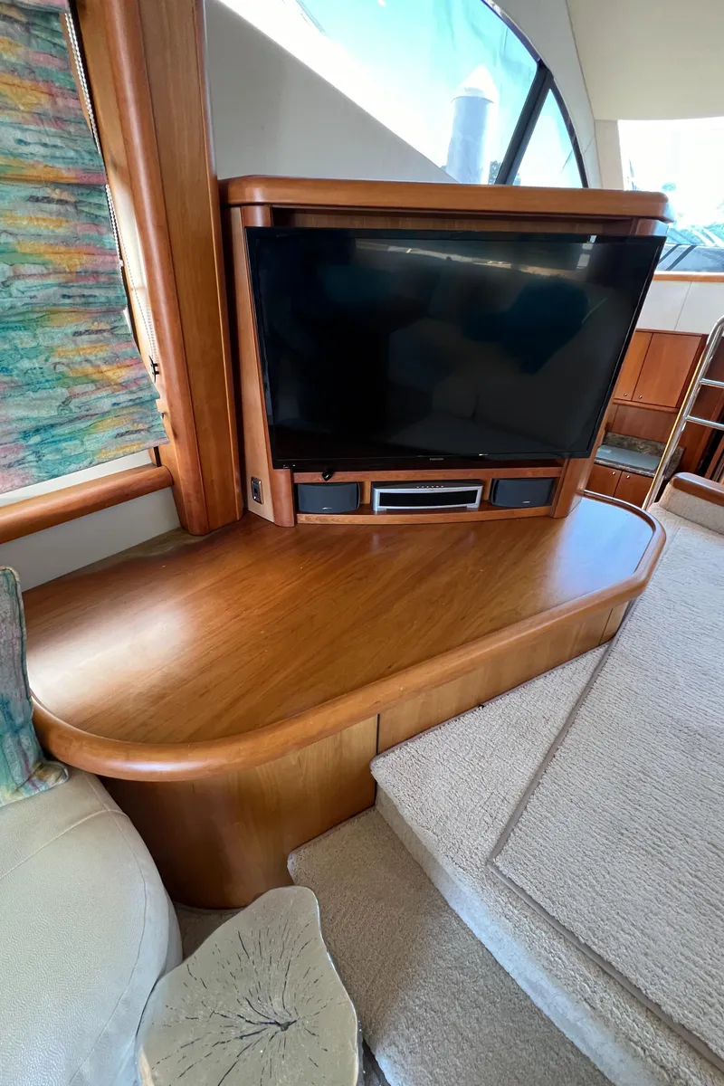 Slide: The Image of 2008 Sunseeker Manhattan 50 yacht interior with TV and wooden cabinetry. - 26