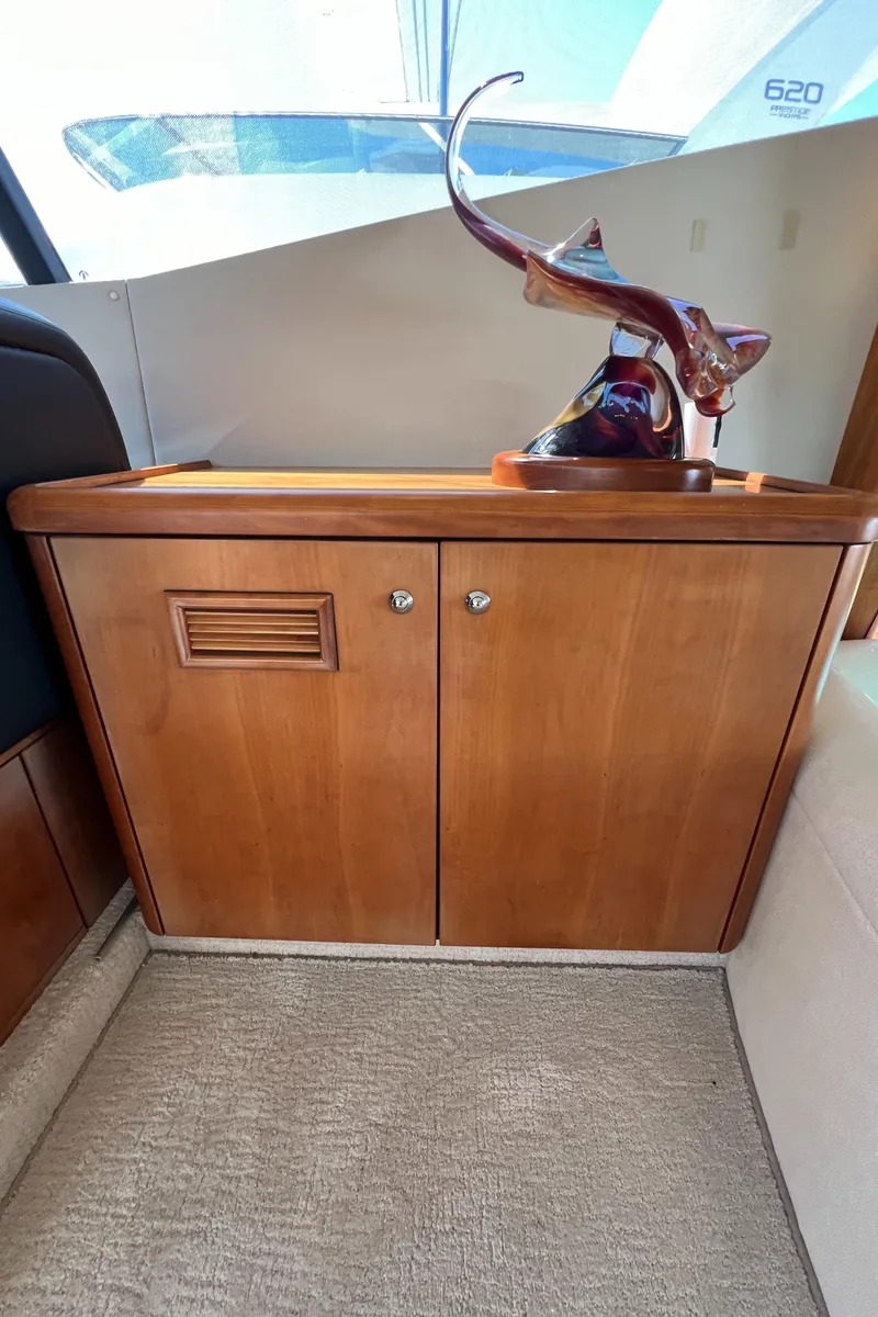Slide: The Image of 2008 Sunseeker Manhattan 50 yacht interior with wooden cabinet and decorative sculpture. - 27