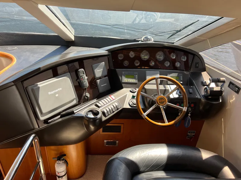 Slide: The Image of Helm of 2008 Sunseeker Manhattan 50 yacht with modern navigation equipment and steering wheel. - 29