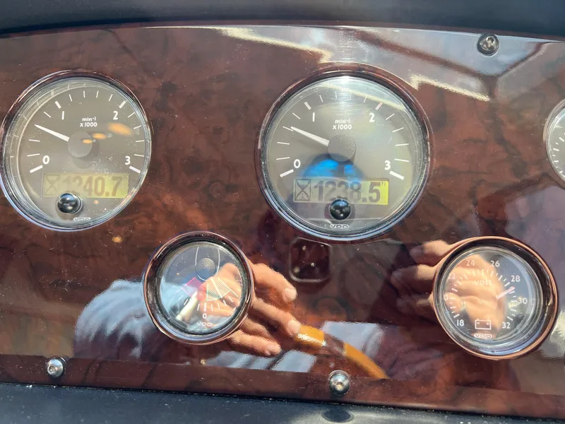 Slide: The Image of Dashboard of a 2008 Sunseeker Manhattan 50 yacht with various gauges and reflections. - 32