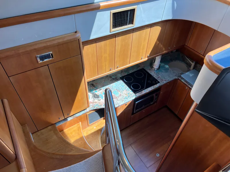 Slide: The Image of Luxurious kitchen interior of 2008 Sunseeker Manhattan 50 yacht with wooden cabinetry and modern appliances. - 34