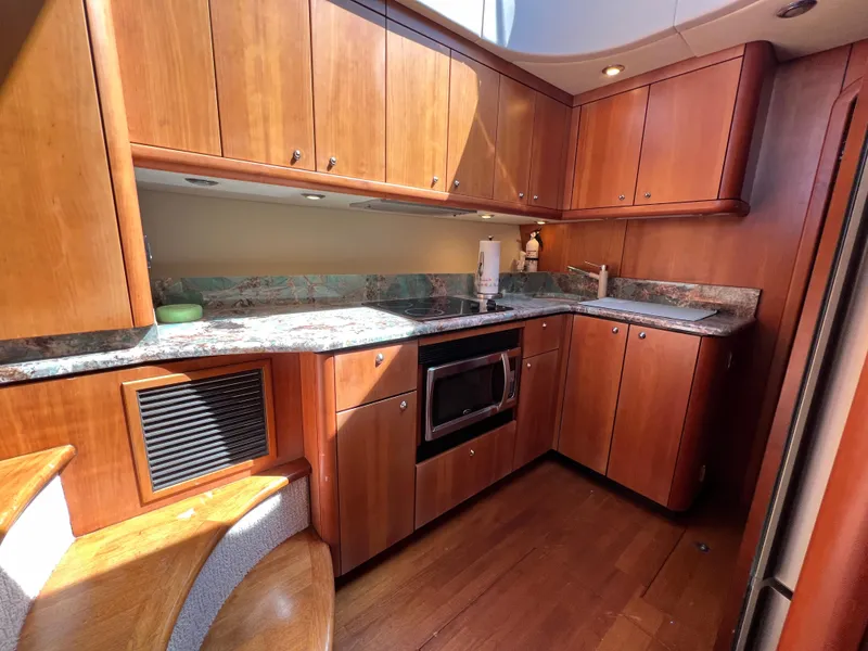 Slide: The Image of Luxurious 2008 Sunseeker Manhattan 50 yacht kitchen with wood cabinetry and modern appliances. - 35