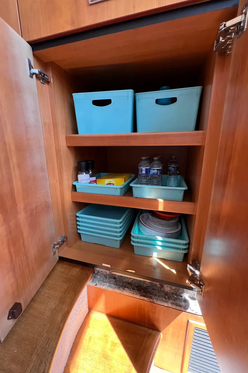 Slide: The Image of Cabinet storage with turquoise bins in 2008 Sunseeker Manhattan 50 yacht. - 42