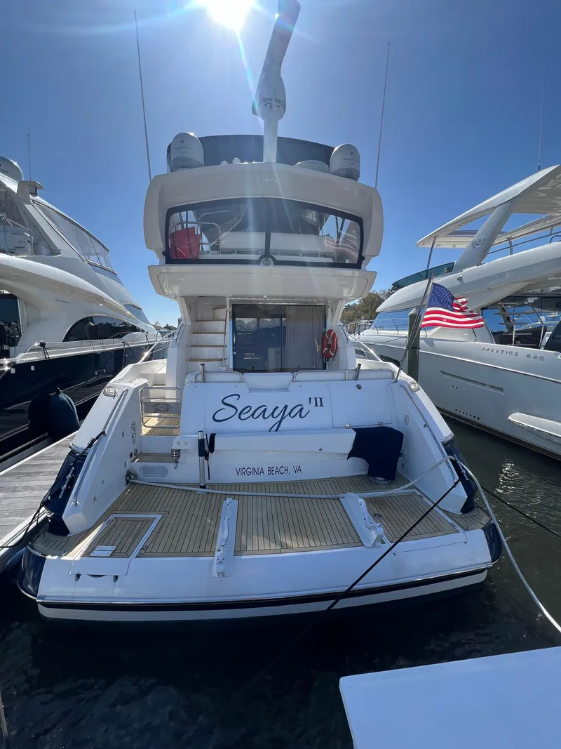 Slide: The Image of 2008 Sunseeker Manhattan 50 yacht docked, rear view with "Seaya" name visible. - 5
