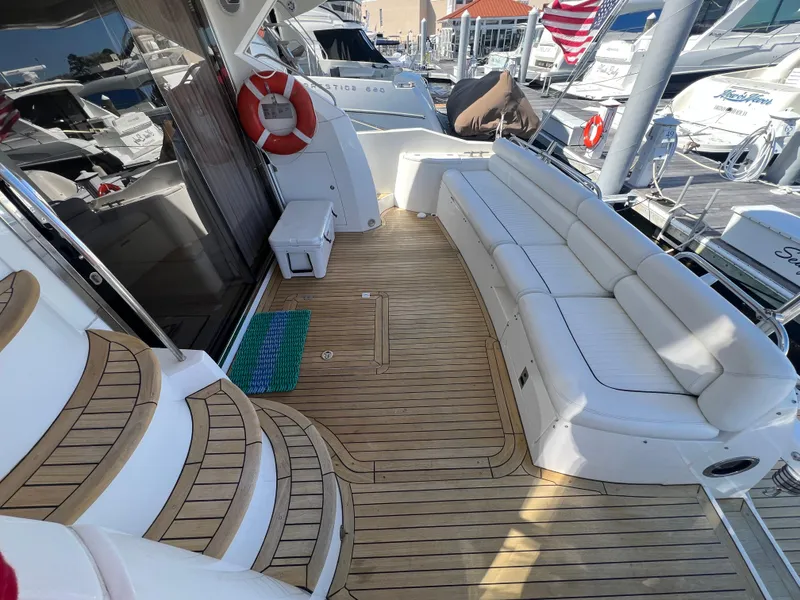 Slide: The Image of Luxurious 2008 Sunseeker Manhattan 50 yacht deck with white seating and wooden flooring. - 6