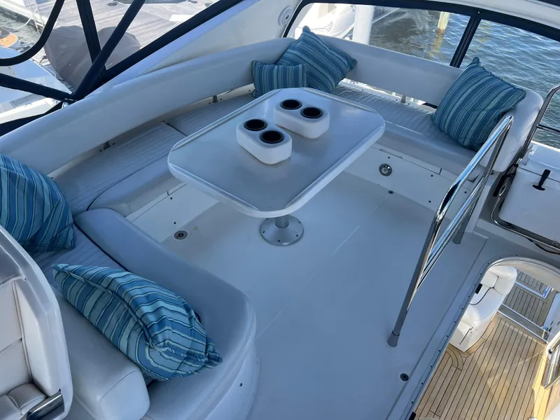 Slide: The Image of Luxurious seating area on 2008 Sunseeker Manhattan 50 yacht with striped cushions and table. - 9