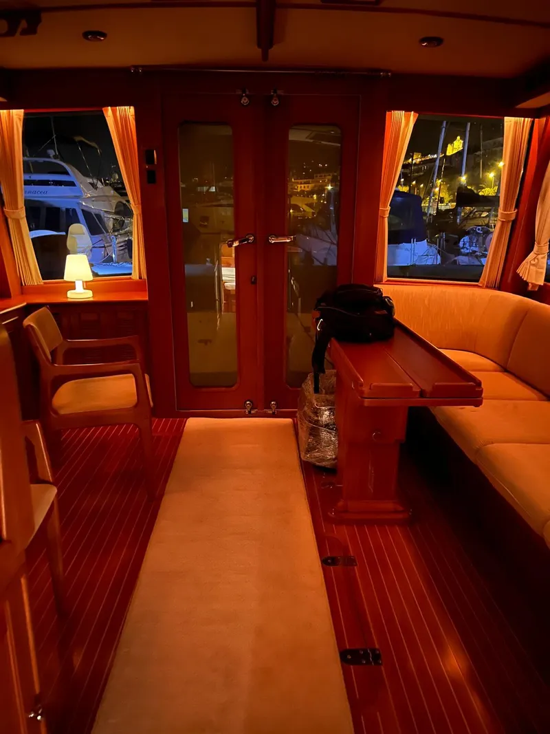 Slide: The Image of Luxurious interior of 2004 Grand Banks Eastbay 54 SX yacht with warm lighting and elegant furnishings. - 10