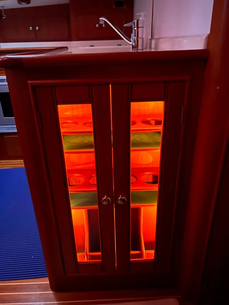 Slide: The Image of Illuminated cabinet with glass doors on a 2004 Grand Banks Eastbay 54 SX yacht. - 12