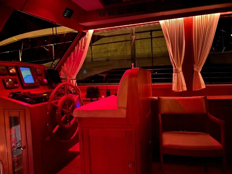 Slide: The Image of Luxurious 2004 Grand Banks Eastbay 54 SX yacht interior with red lighting and elegant furnishings. - 13