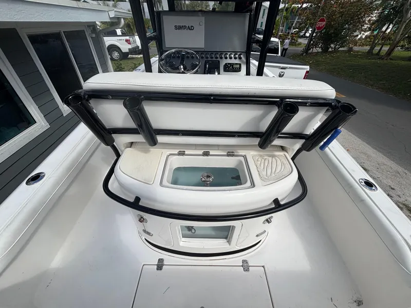 Slide: The Image of 2016 ShearWater 260 Carolina Bay boat interior with fishing rod holders and control panel. - 12