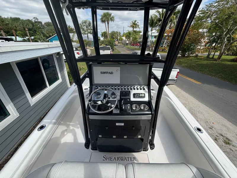 Slide: The Image of 2016 ShearWater 260 Carolina Bay boat console with steering wheel and controls. - 13