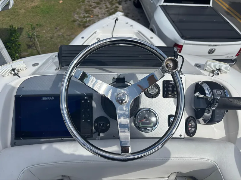 Slide: The Image of Steering wheel and dashboard of 2016 ShearWater 260 Carolina Bay boat. - 16