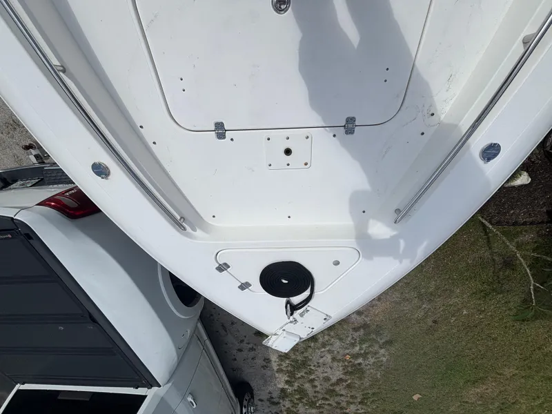 Slide: The Image of 2016 ShearWater 260 Carolina Bay boat deck, viewed from above, near a parked vehicle. - 19