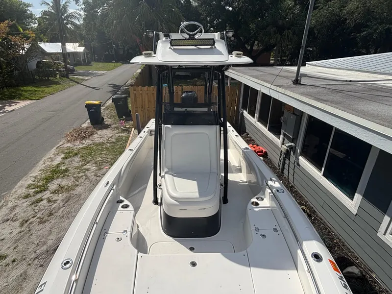 Slide: The Image of 2016 ShearWater 260 Carolina Bay boat, top view, parked near a house. - 22