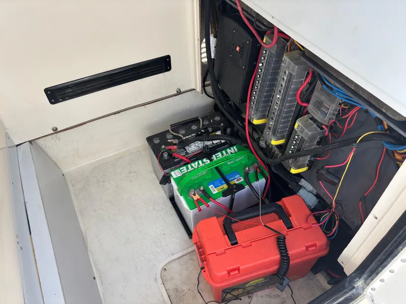 Slide: The Image of Electrical compartment of a 2016 ShearWater 260 Carolina Bay boat with battery and wiring. - 28