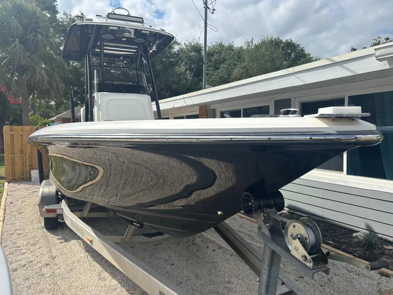 Slide: The Image of 2016 ShearWater 260 Carolina Bay boat on trailer, parked outdoors near a building. - 4