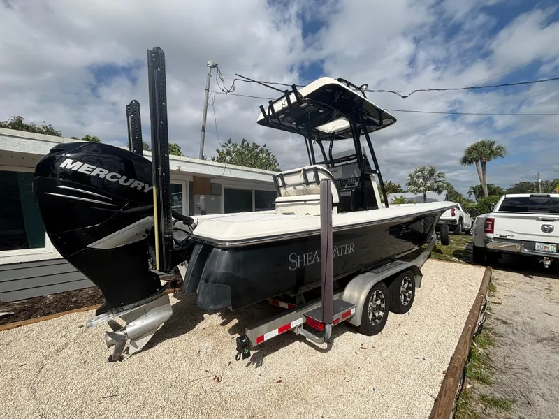 Slide: The Image of 2016 ShearWater 260 Carolina Bay boat on trailer, featuring a Mercury outboard motor. - 5