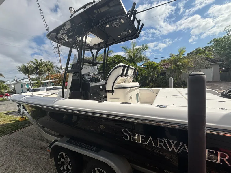Slide: The Image of 2016 ShearWater 260 Carolina Bay boat on trailer, parked outdoors under a cloudy sky. - 9