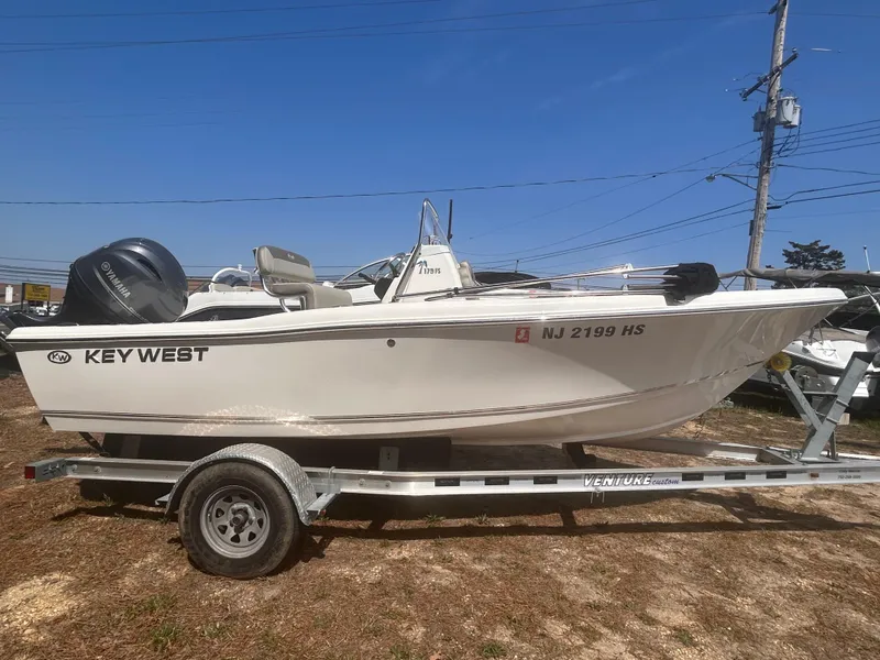 Slide: The Image of 2022 Key West 179FS boat on trailer, side view, clear sky background. - 1