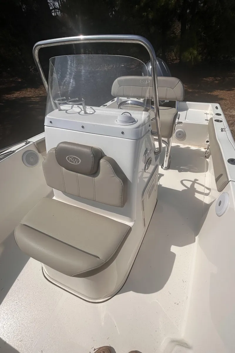 Slide: The Image of 2022 Key West 179FS boat interior with seating and console, featuring a sleek design. - 4