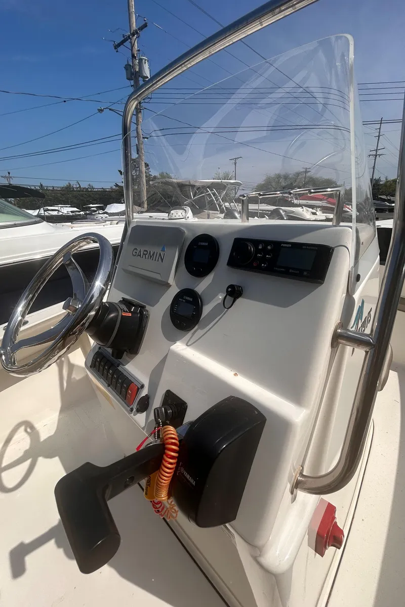 Slide: The Image of 2022 Key West 179FS boat console with steering wheel and navigation instruments. - 5