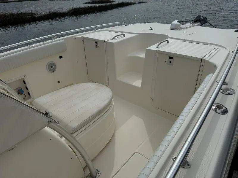 Slide: The Image of 2003 World Cat 330 TE boat interior with seating and storage compartments. - 10