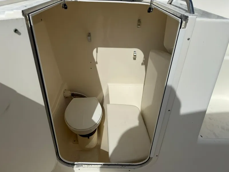 Slide: The Image of 2003 World Cat 330 TE boat interior with compact marine toilet. - 12