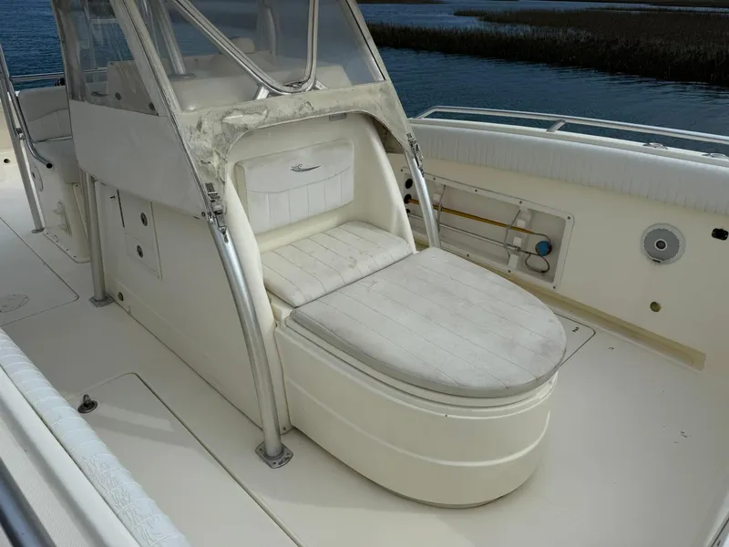 Slide: The Image of 2003 World Cat 330 TE boat interior with seating and storage compartments. - 13