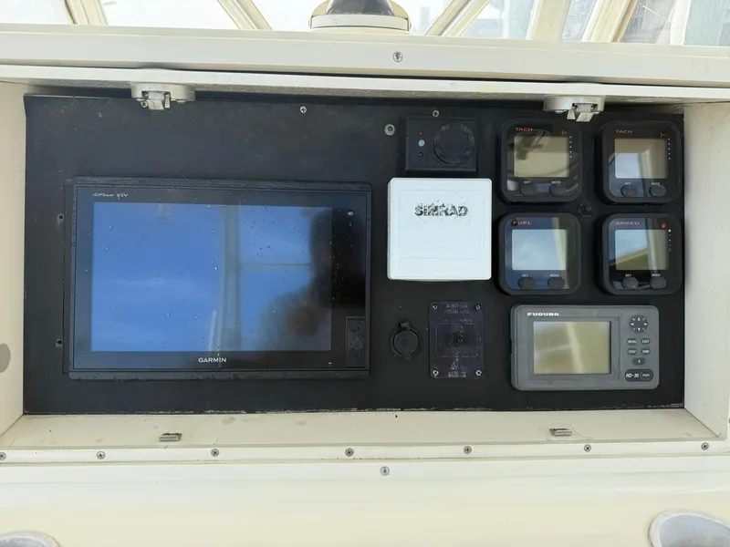 Slide: The Image of 2003 World Cat 330 TE dashboard with navigation and control displays. - 16