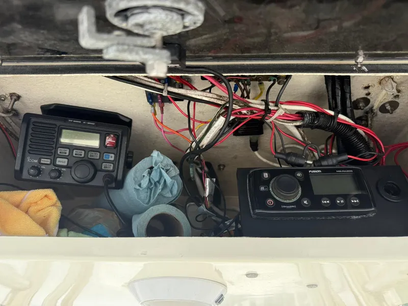Slide: The Image of 2003 World Cat 330 TE boat electronics and wiring compartment with radios and cables. - 17