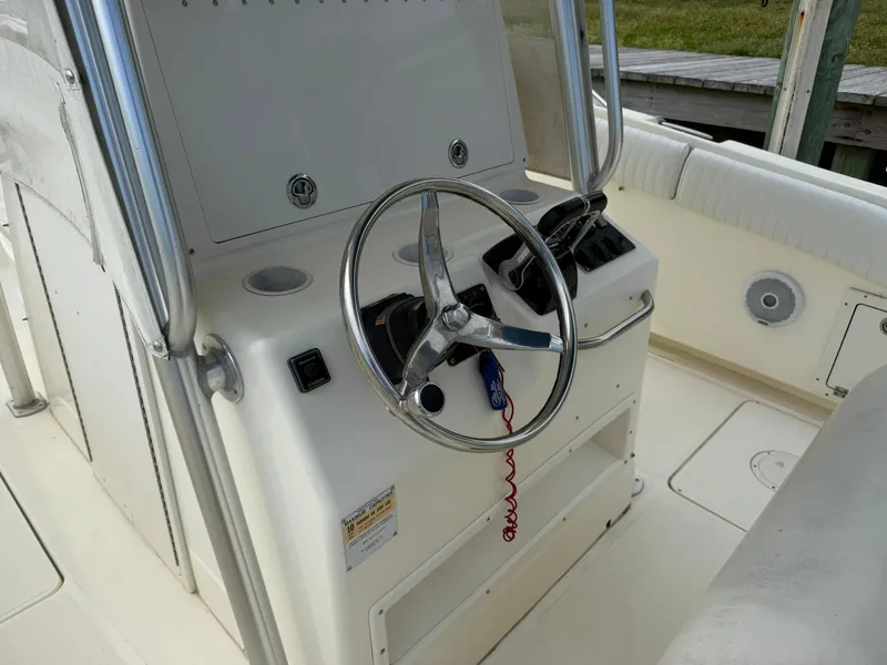 Slide: The Image of 2003 World Cat 330 TE boat steering console with stainless steel wheel and controls. - 18