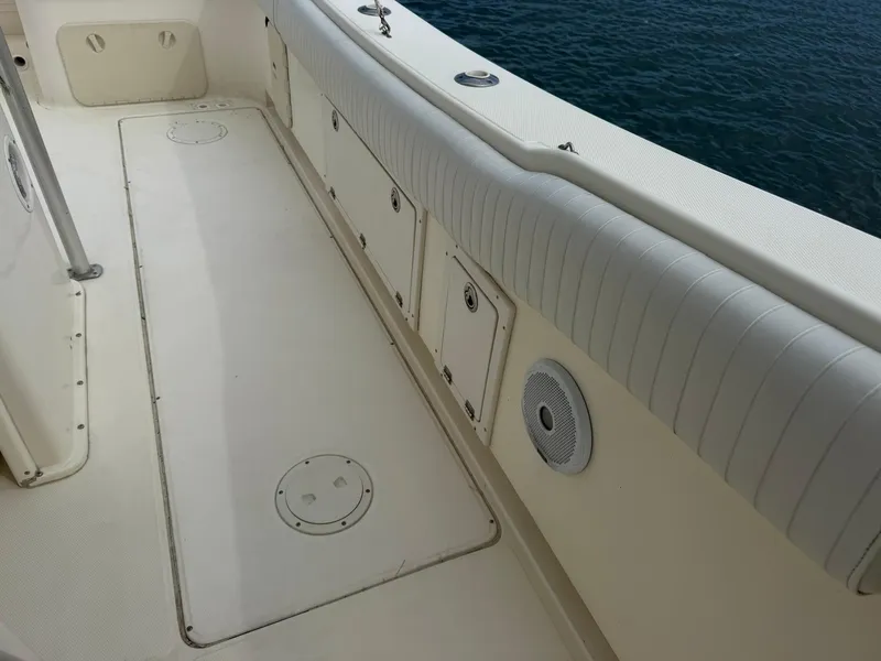 Slide: The Image of 2003 World Cat 330 TE boat deck with storage compartments and speaker, near water. - 20