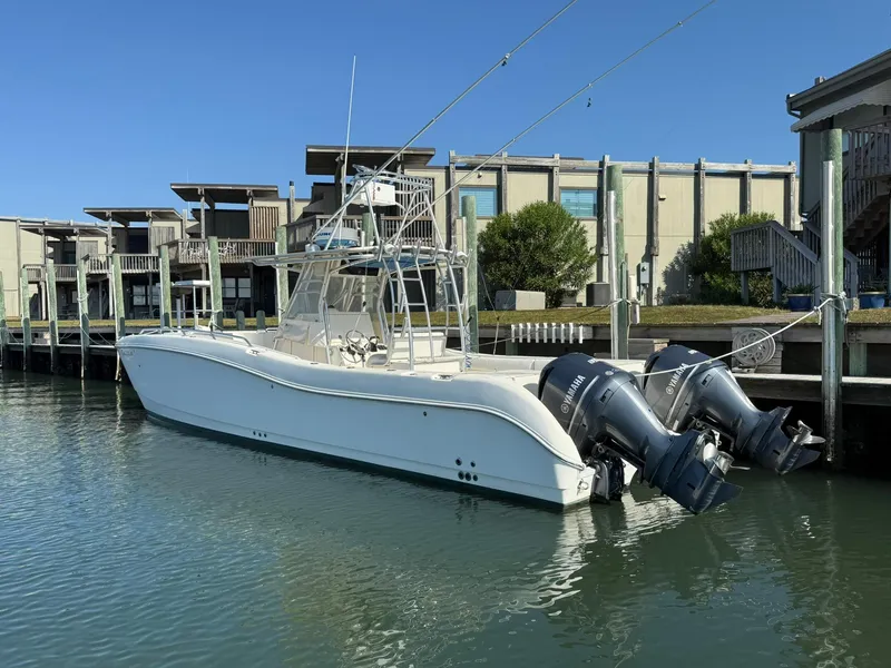 Slide: The Image of 2003 World Cat 330 TE boat docked with dual outboard engines. - 3