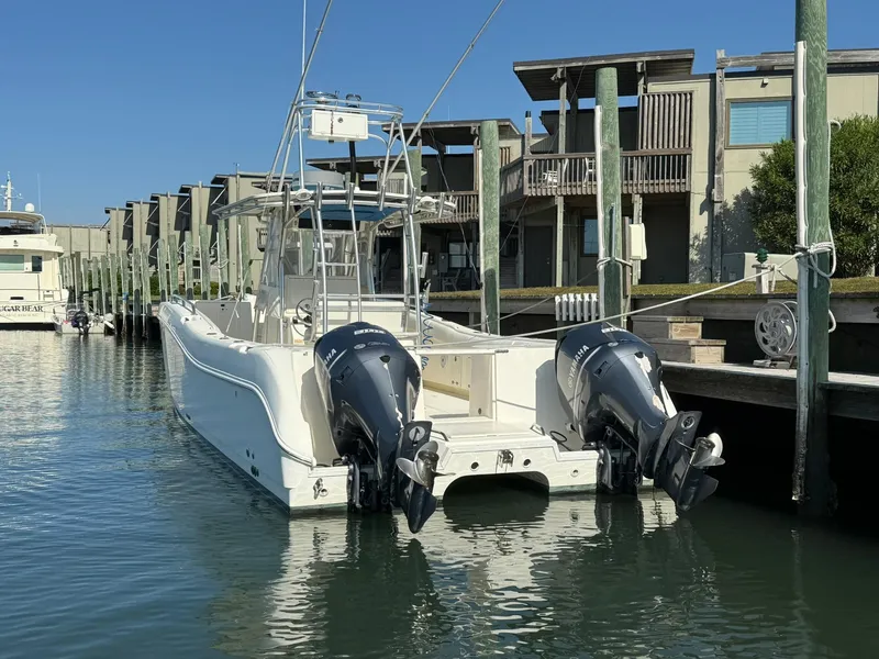 Slide: The Image of 2003 World Cat 330 TE boat docked with twin outboard engines. - 4