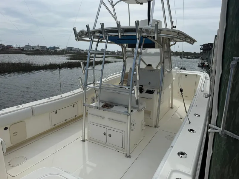 Slide: The Image of 2003 World Cat 330 TE boat docked by a calm waterway. - 8