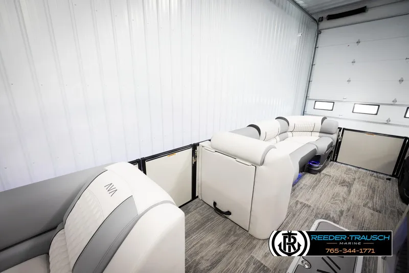 Slide: The Image of Interior of 2025 Avalon Excalibur LTD CRB boat with luxurious seating in a showroom. - 22