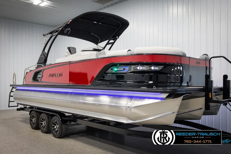 Slide: The Image of 2025 Avalon Excalibur LTD CRB pontoon boat with sleek design and modern features in showroom. - 3