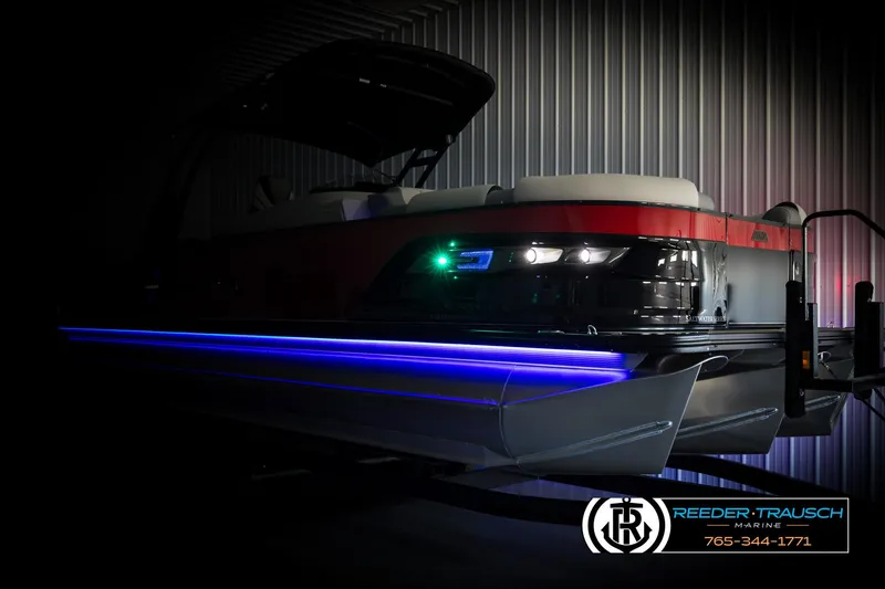 Slide: The Image of 2025 Avalon Excalibur LTD CRB boat with LED lights in a dimly lit setting. - 4