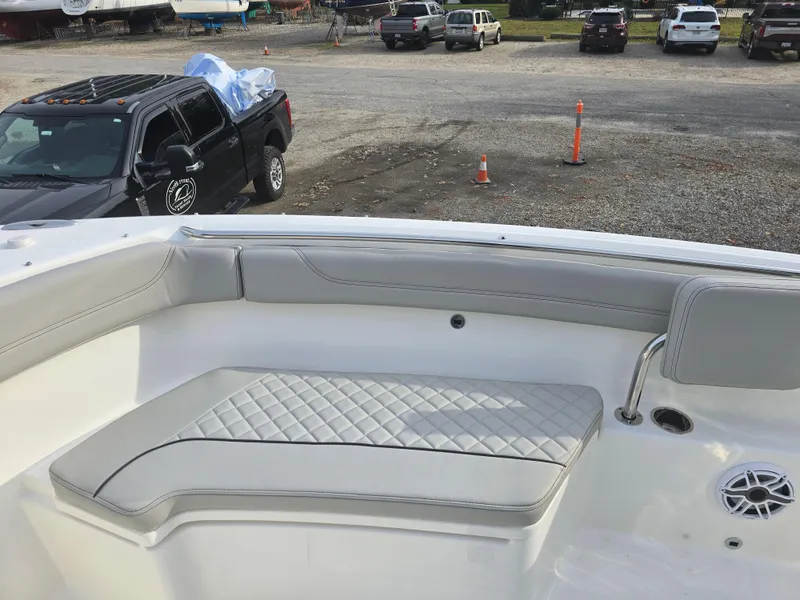 Slide: The Image of 2025 Pursuit S 288 boat interior with cushioned seating and sleek design. - 11