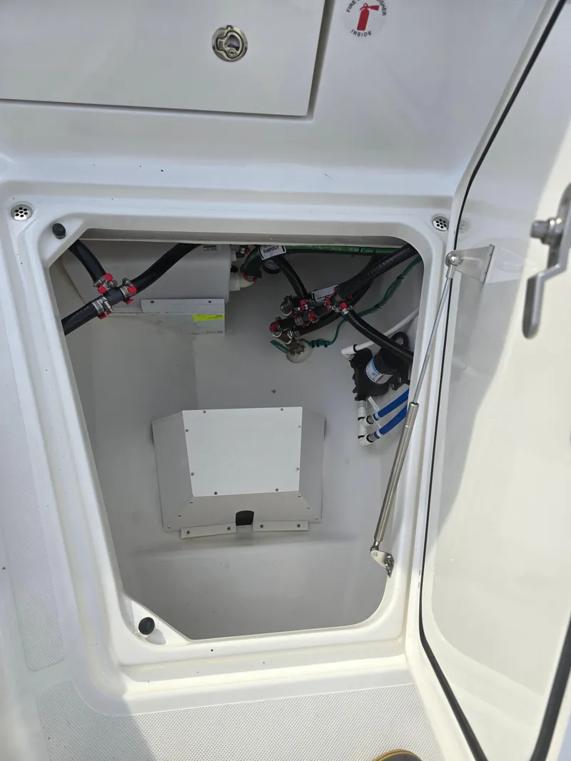 Slide: The Image of 2025 Pursuit S 288 boat compartment with wiring and equipment. - 17