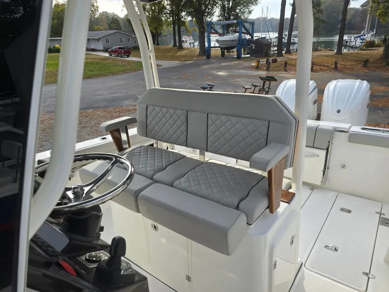 Slide: The Image of 2025 Pursuit S 288 boat interior with gray quilted seating and dual engines. - 20