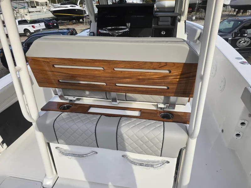Slide: The Image of 2025 Pursuit S 288 boat interior with wood accents and quilted seating. - 23
