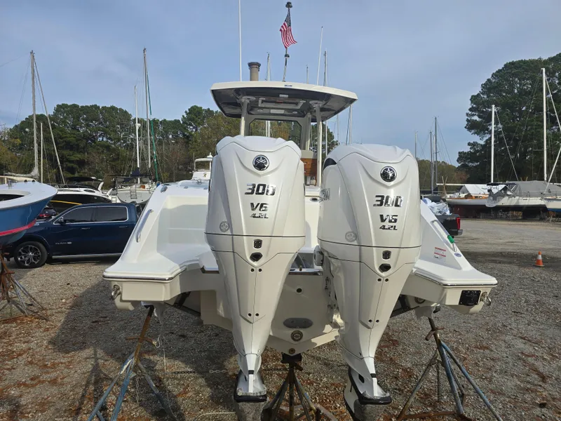 Slide: The Image of 2025 Pursuit S 288 boat with twin 300 V6 engines in a marina. - 4