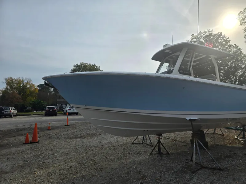 Slide: The Image of 2025 Pursuit S 288 boat on stands in a parking area, side view. - 7