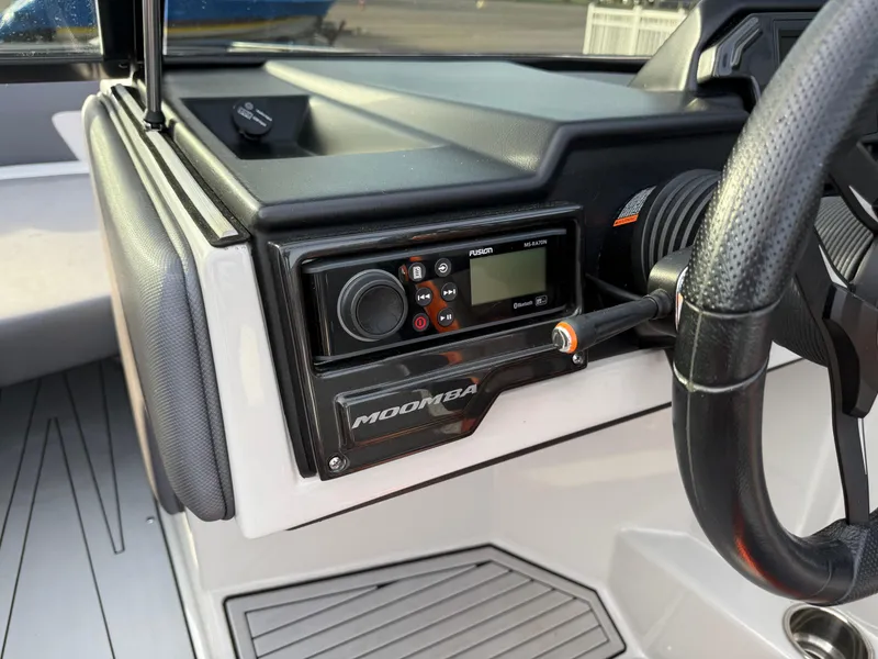 Slide: The Image of 2018 Moomba Helix boat dashboard with control panel and steering wheel. - 16