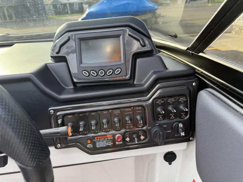 Slide: The Image of Control panel of a 2018 Moomba Helix boat with display and switches. - 19